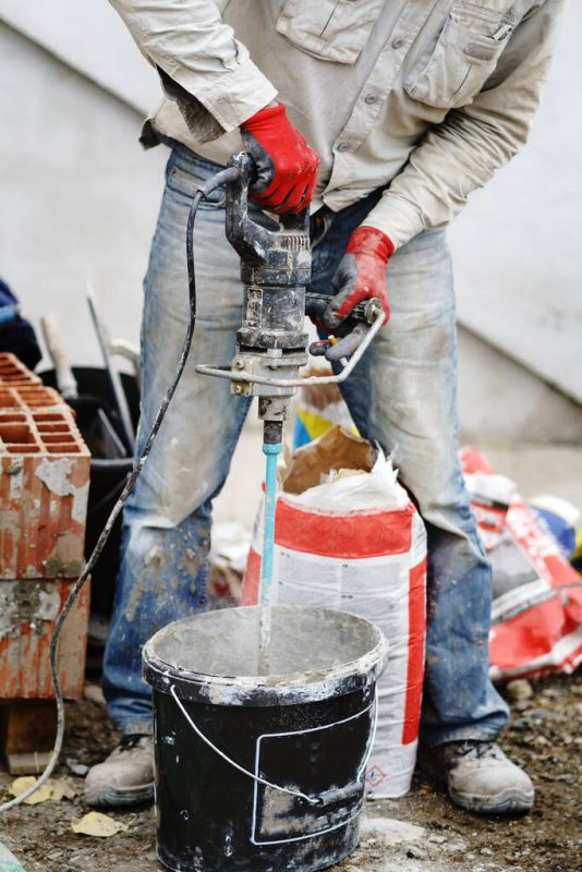 stock photo close midsection unknown man using hand electric drill mixer prepare
